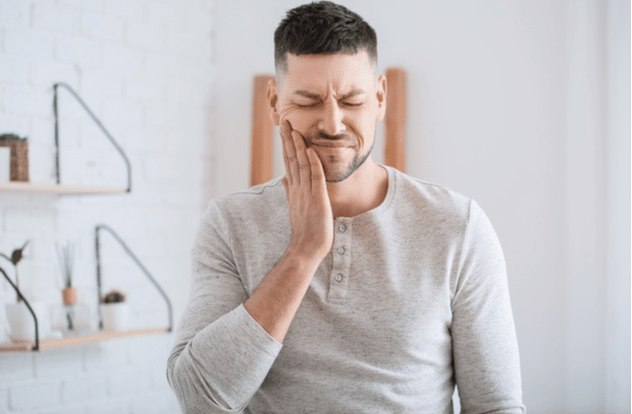Man suffering from tooth ache in morning